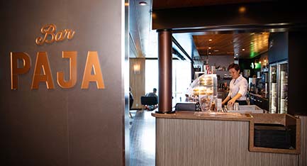Bar Paja staff member behind the bar counter