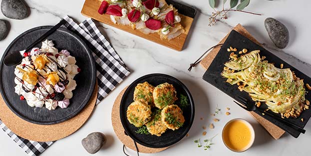 Nordic buffet dishes on black plates.